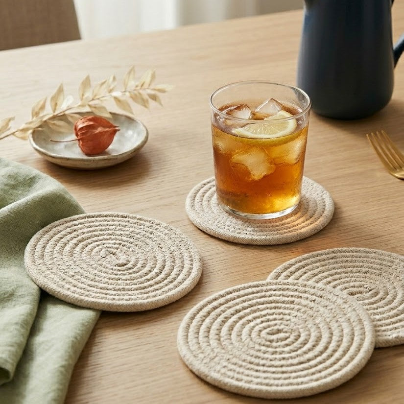Portavaso minimalista artesanal Lilia Baez en color Crudo natural, fabricado en cordón enrollado de alta precisión. Accesorio sutil y elegante para ambientes sofisticados