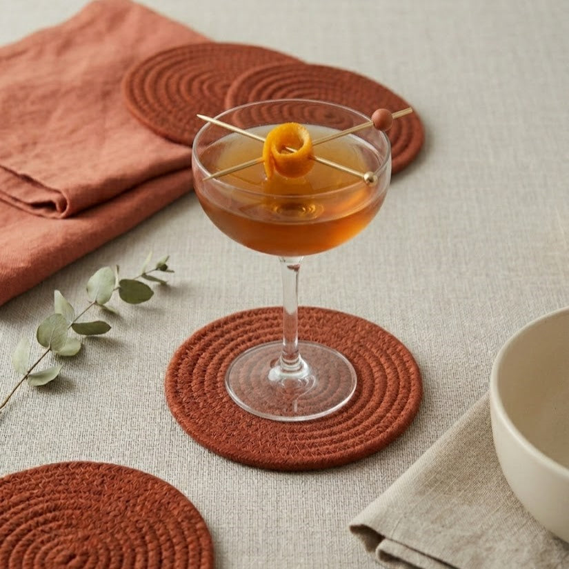 Portavaso artesanal minimalista Lilia Baez en color Terracota. Pieza de autor en cordón enrollado para una decoración de mesa con calidez artesanal y lujo.